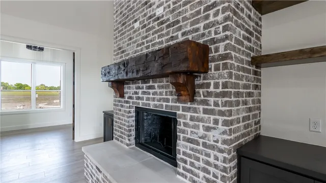 a living room with stainless steel appliances kitchen island hardwood floor and a view of kitchen