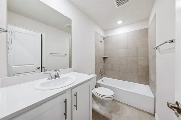 a bathroom with a sink a toilet a mirror and shower