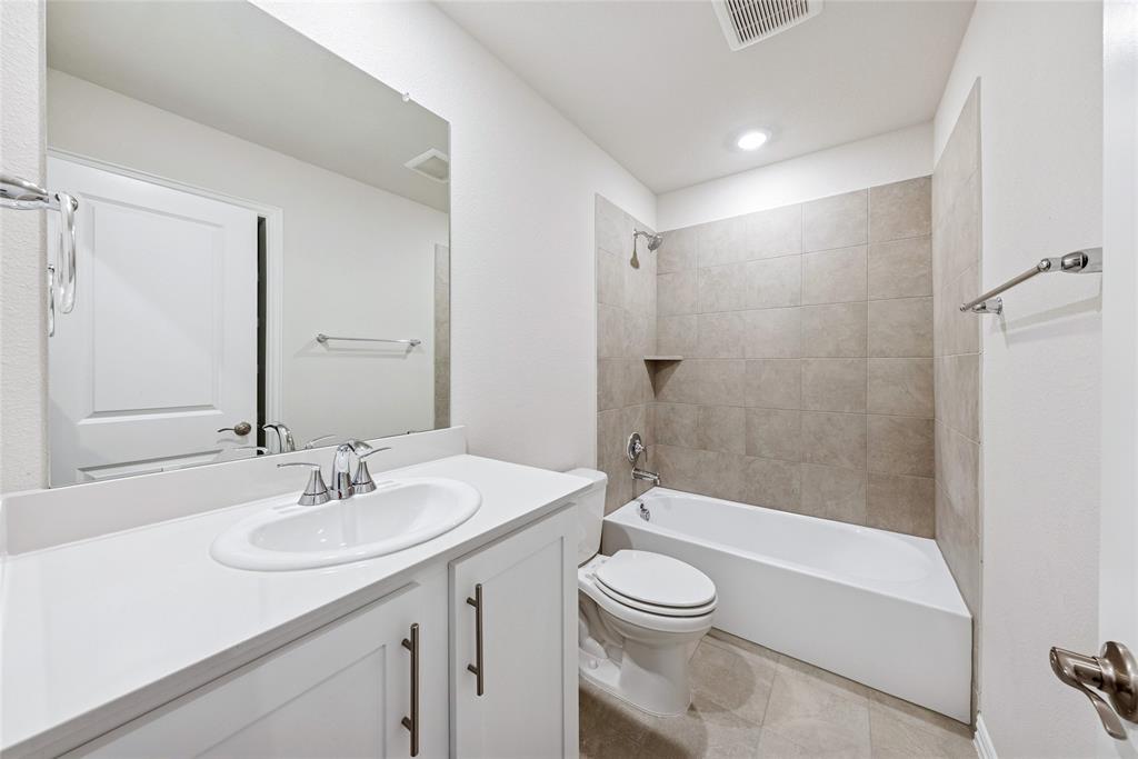 2221 Horseshoe Lane Seagoville, TX 75159 - Photo 13 of 21 a bathroom with a sink a toilet a mirror and shower
