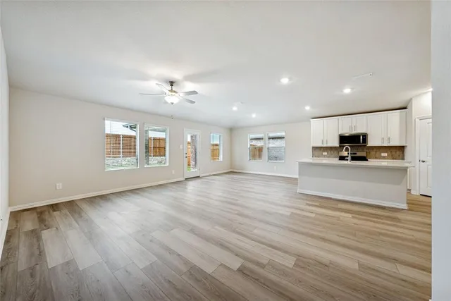 a view of a kitchen with a sink and a large window