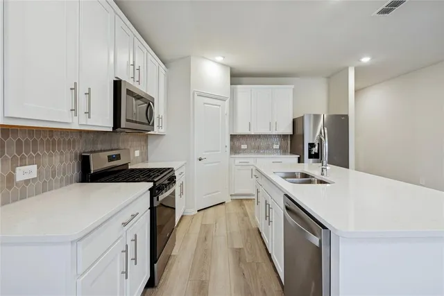 a kitchen with a sink a stove and refrigerator