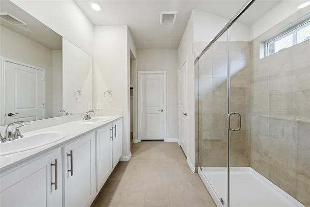 a bathroom with a double vanity sink and mirror