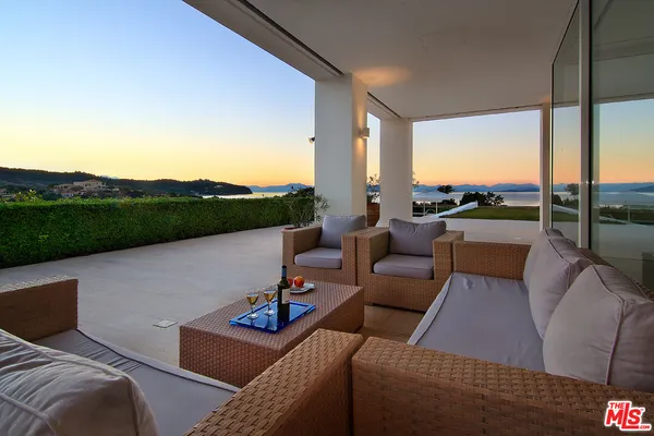 a view of a house with outdoor space and sitting area