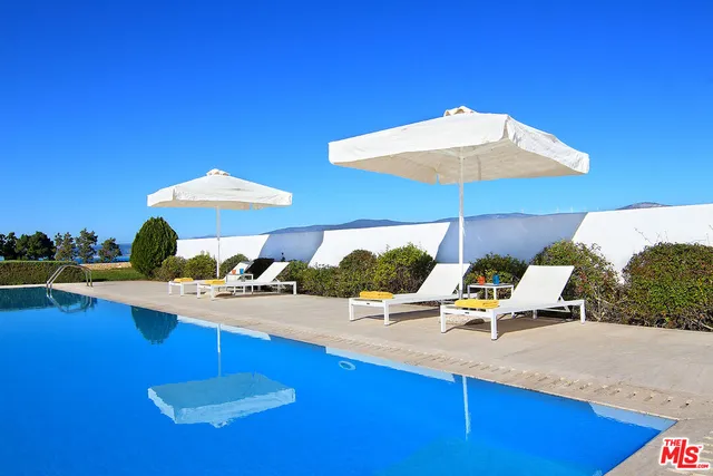 a view of a swimming pool with outdoor seating
