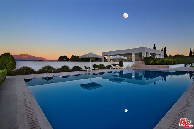 a view of a swimming pool and lounge chair