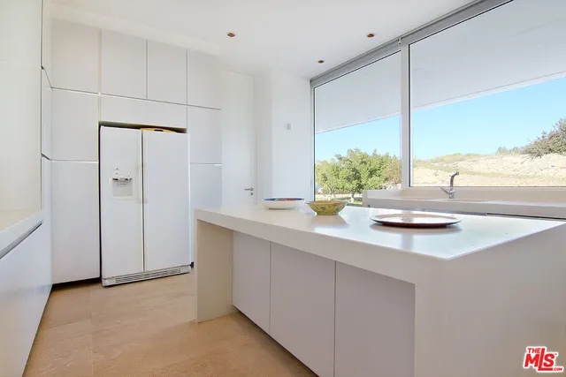a bathroom with a granite countertop sink toilet and a mirror