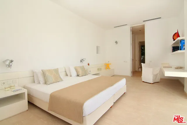 a bedroom with a bed and a couch