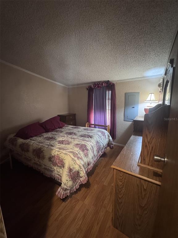 20050 Ruth Street Brooksville, FL 34601 - Photo 14 of 18 a bedroom with a bed and wooden floor