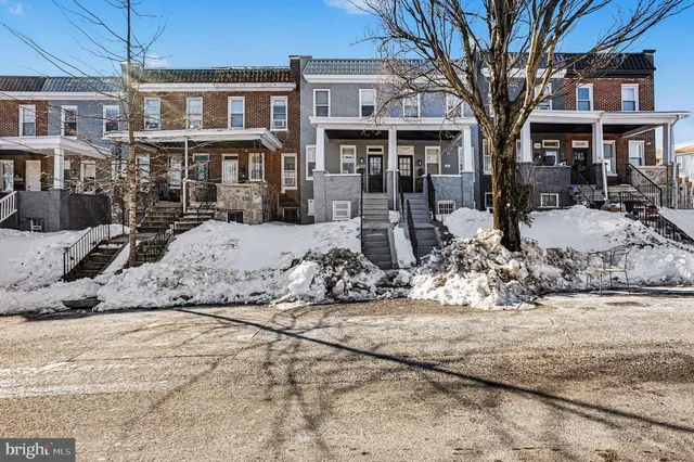 a view of a house with snow on the road