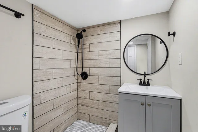 a bathroom with a sink toilet and shower