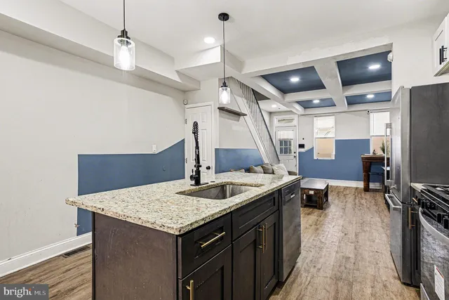 a kitchen with sink cabinets and refrigerator