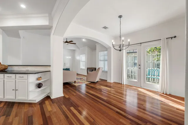 a living room with hard wood floors and a ceiling fan