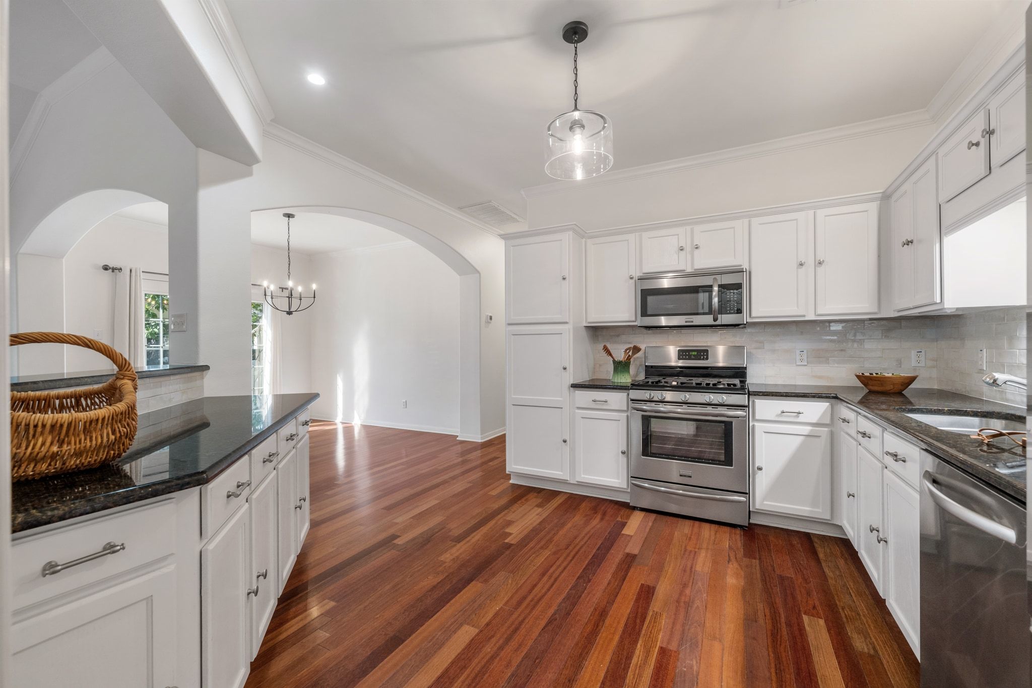 6801 Beckett Road, Unit 134L Austin, TX 78749 - Photo 14 of 30 a kitchen with stainless steel appliances granite countertop wooden cabinets a sink dishwasher a stove and a refrigerator