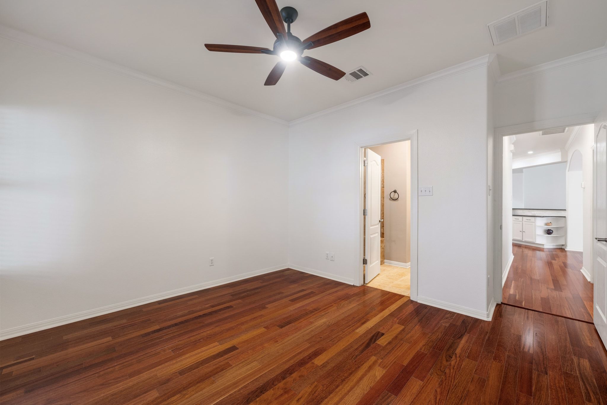 6801 Beckett Road, Unit 134L Austin, TX 78749 - Photo 17 of 30 an empty room with wooden floor and a ceiling fan