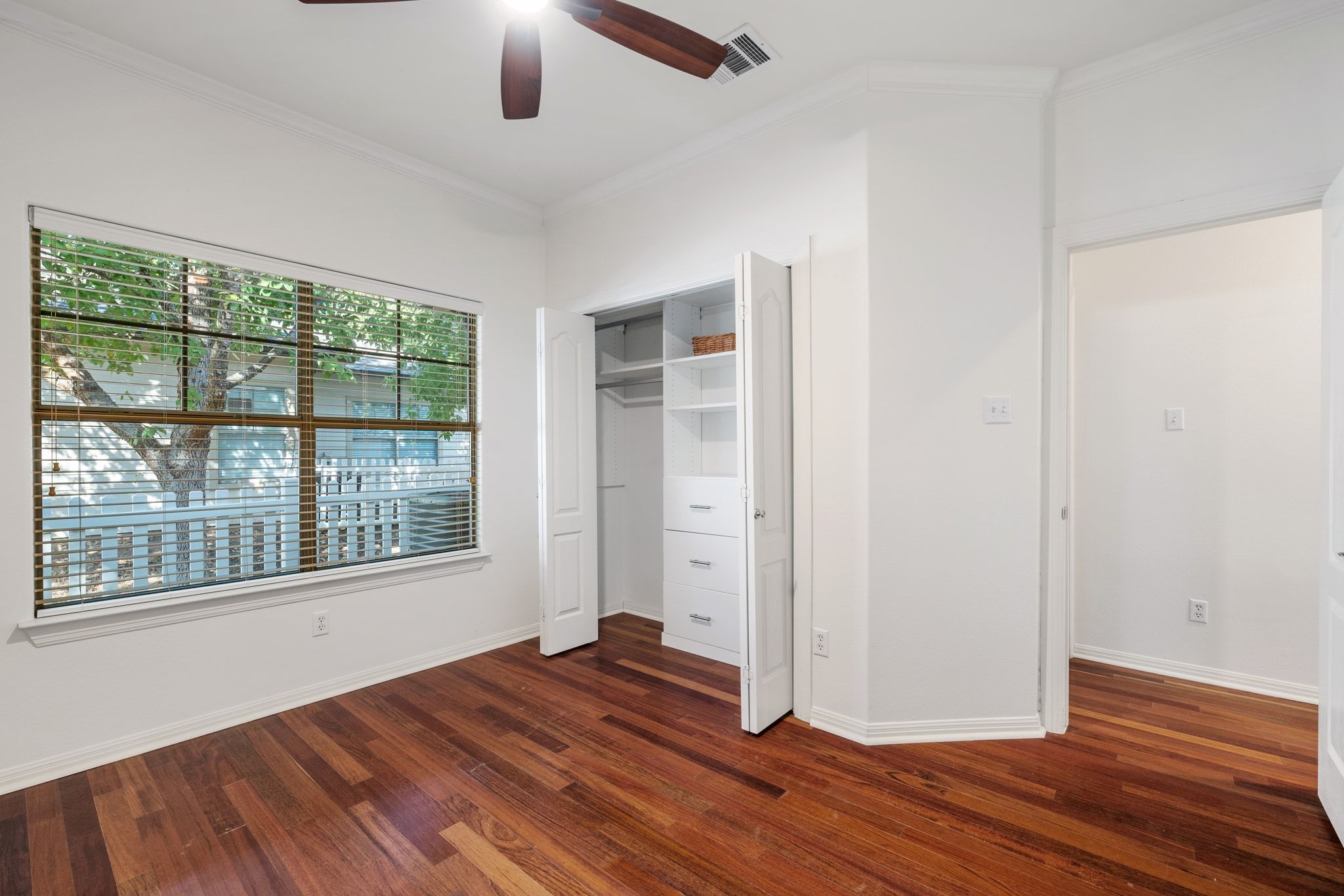 6801 Beckett Road, Unit 134L Austin, TX 78749 - Photo 23 of 30 an empty room with wooden floor and windows