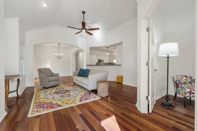 a living room with furniture and wooden floor