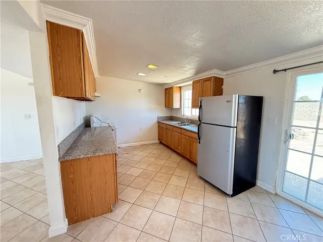 a kitchen with stainless steel appliances granite countertop a refrigerator and a sink