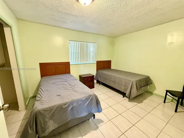 a bedroom with double bed and a window