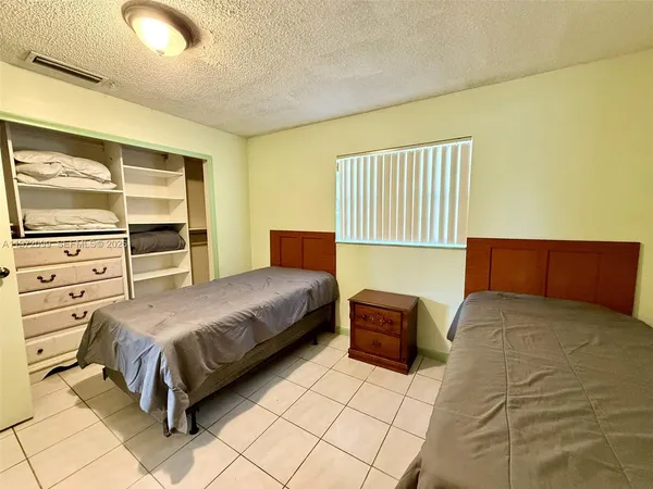 a bedroom with a bed and dresser