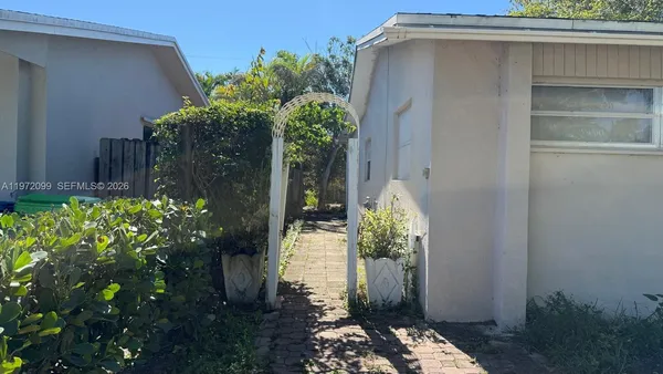 a couple of flower plants in front of door