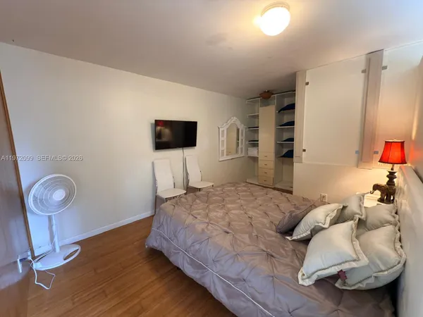 a bedroom with a bed and a television