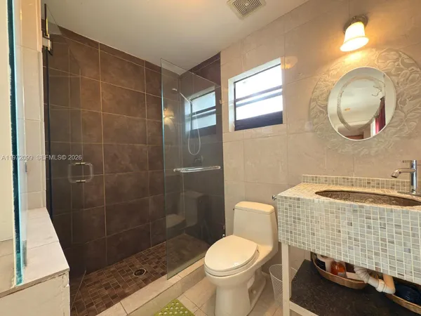 a bathroom with a sink toilet and shower