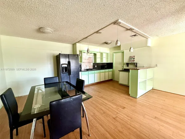 a living room with stainless steel appliances kitchen island granite countertop furniture and a kitchen view