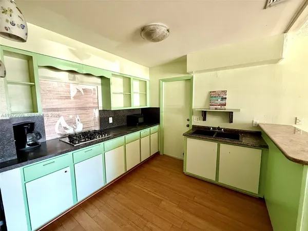 a kitchen with stainless steel appliances granite countertop a sink and wooden cabinets
