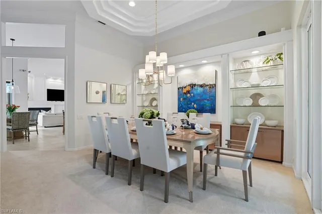 a view of a dining room with furniture and chandelier