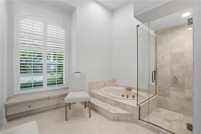 a bathroom with a bathtub and a shower