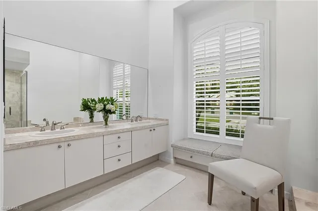 a bathroom with a tub a mirror and shower