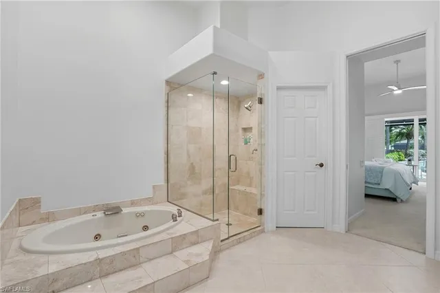 a bedroom with furniture and a large window