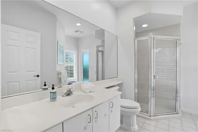 a kitchen with granite countertop white cabinets and a sink