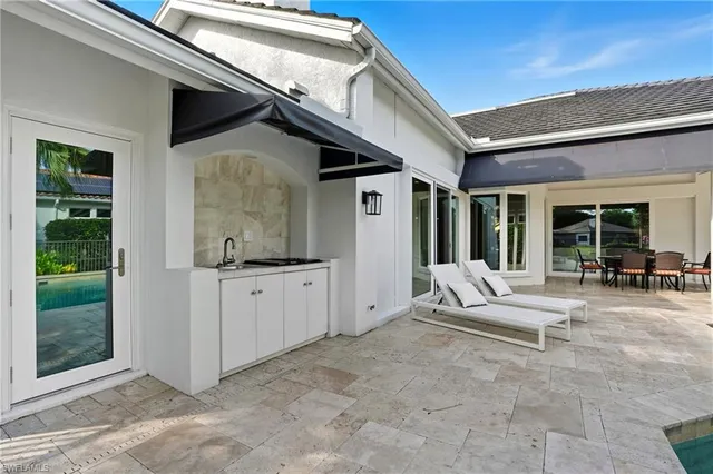 a living room with furniture and large windows