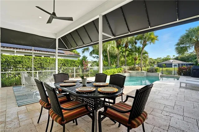 an aerial view of a house with a yard and lake view