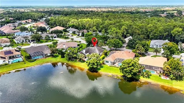 an aerial view of a house with a yard and potted plants