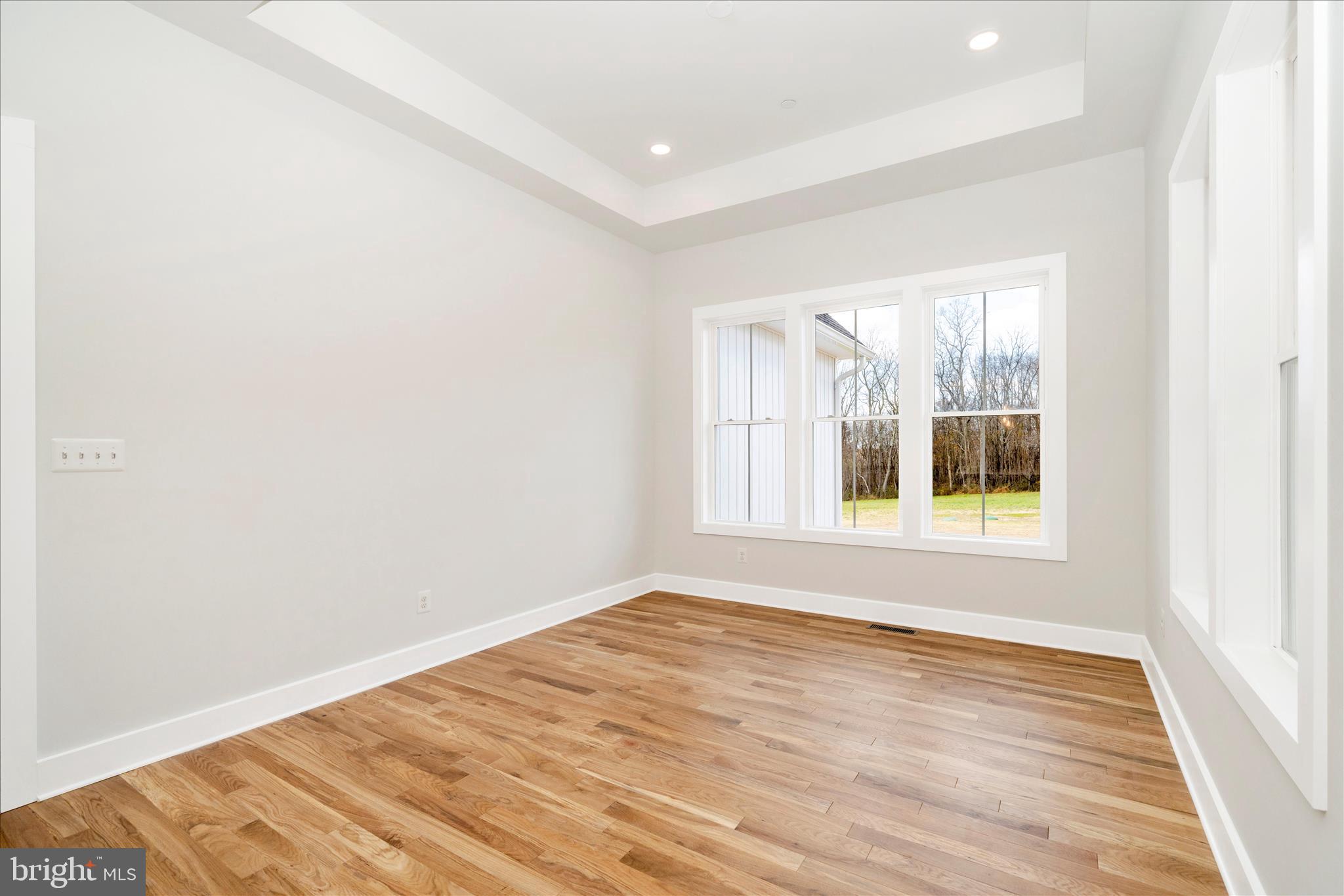 15030 New Windsor Road New Windsor, MD 21776 - Photo 19 of 63 an empty room with wooden floor and windows