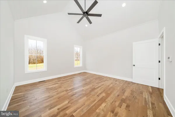 a view of empty room with wooden floor