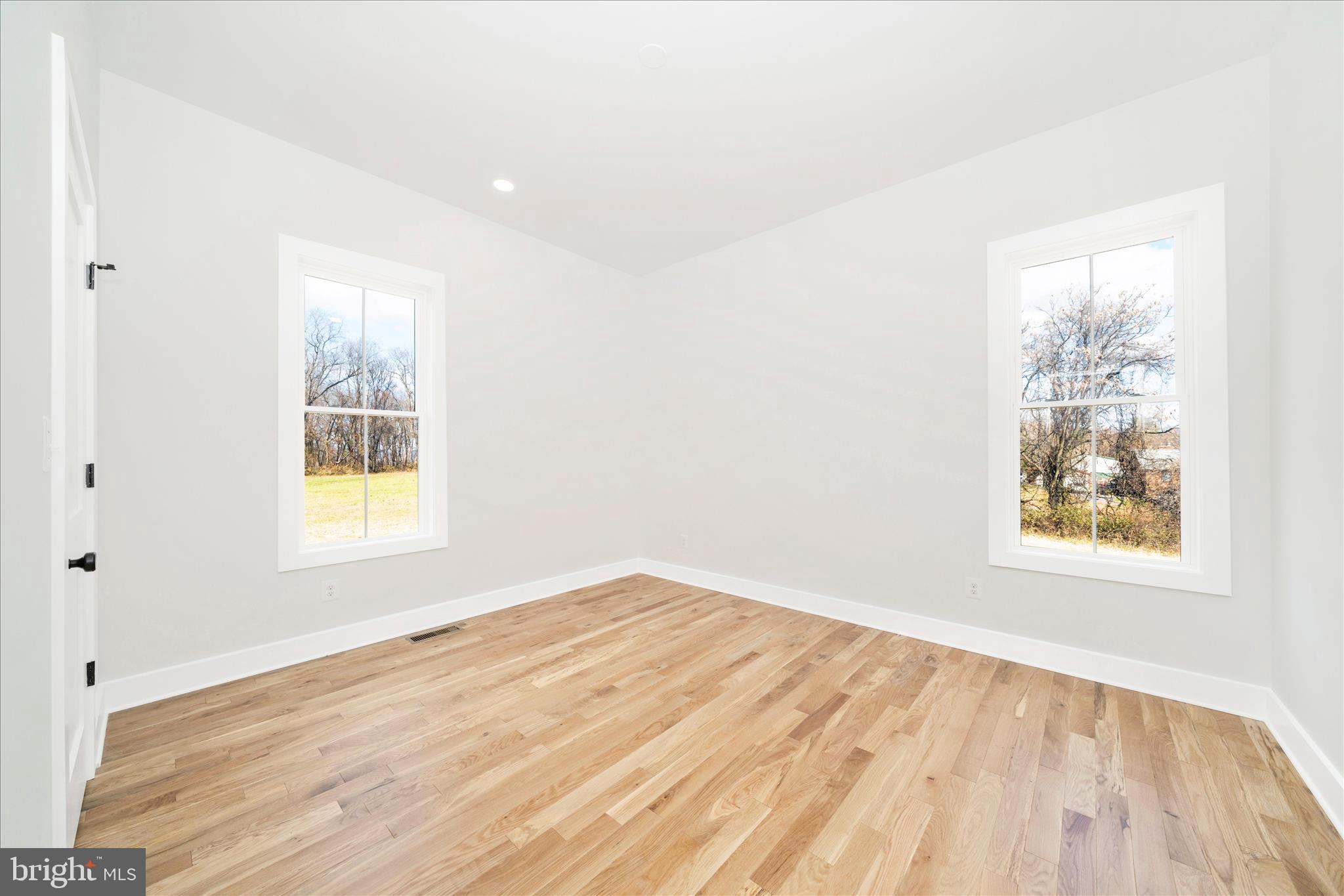 15030 New Windsor Road New Windsor, MD 21776 - Photo 35 of 63 an empty room with wooden floor and windows
