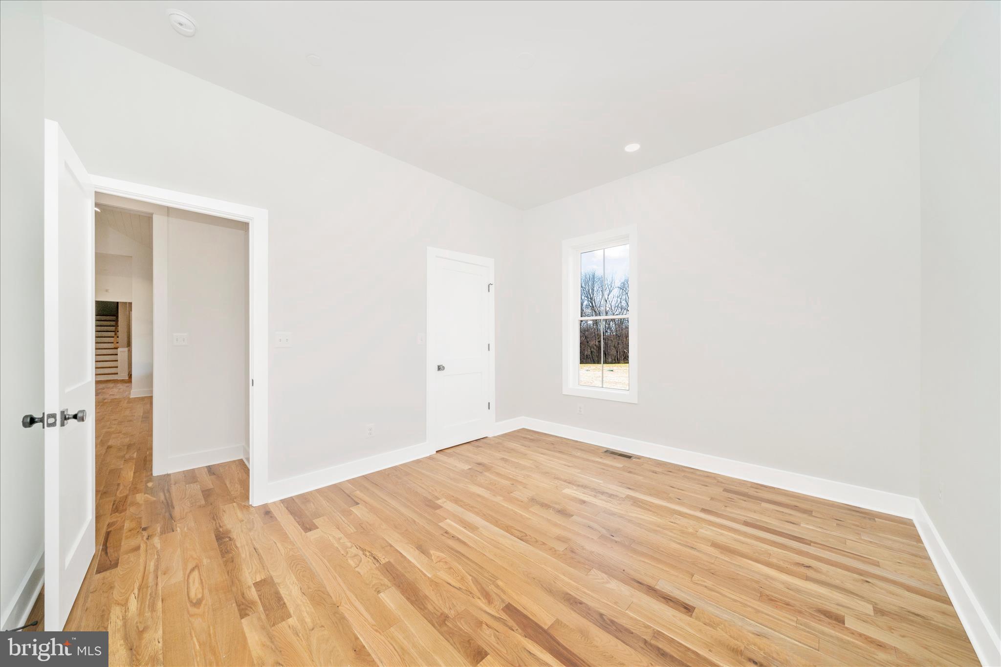 15030 New Windsor Road New Windsor, MD 21776 - Photo 36 of 63 a view of empty room with wooden floor and fan