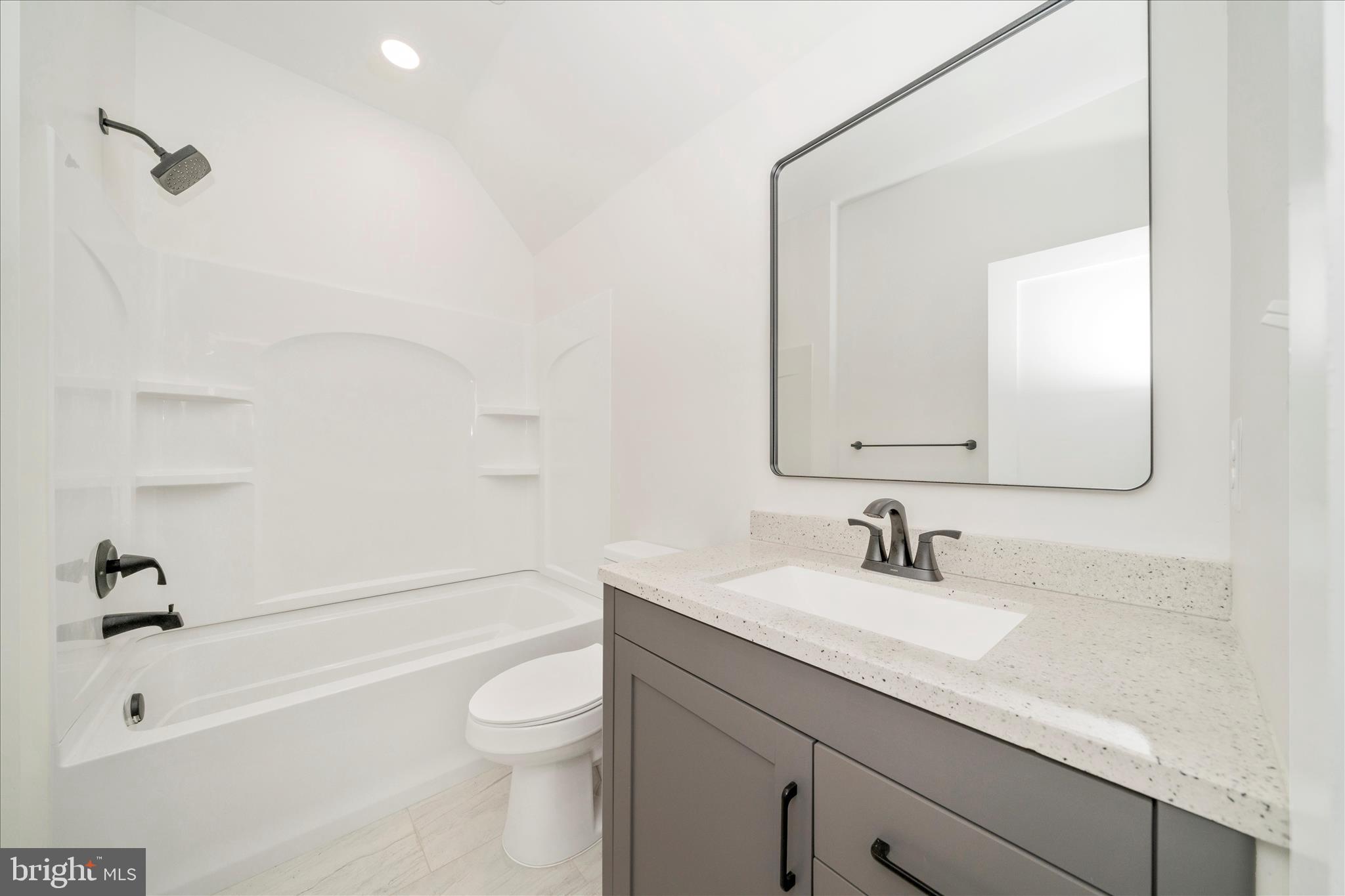 15030 New Windsor Road New Windsor, MD 21776 - Photo 44 of 63 a bathroom with a granite countertop sink a toilet and a bathtub
