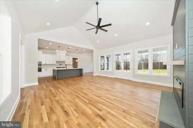 a large kitchen with kitchen island a sink appliances and a counter top space