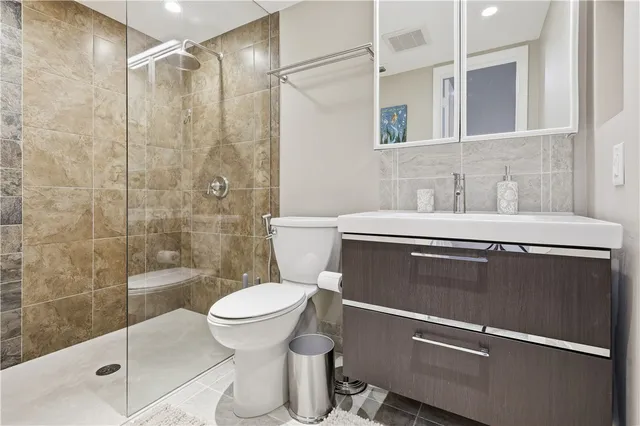 a bathroom with a sink toilet and shower