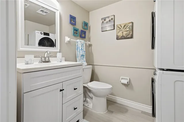a bathroom with a sink mirror vanity and toilet