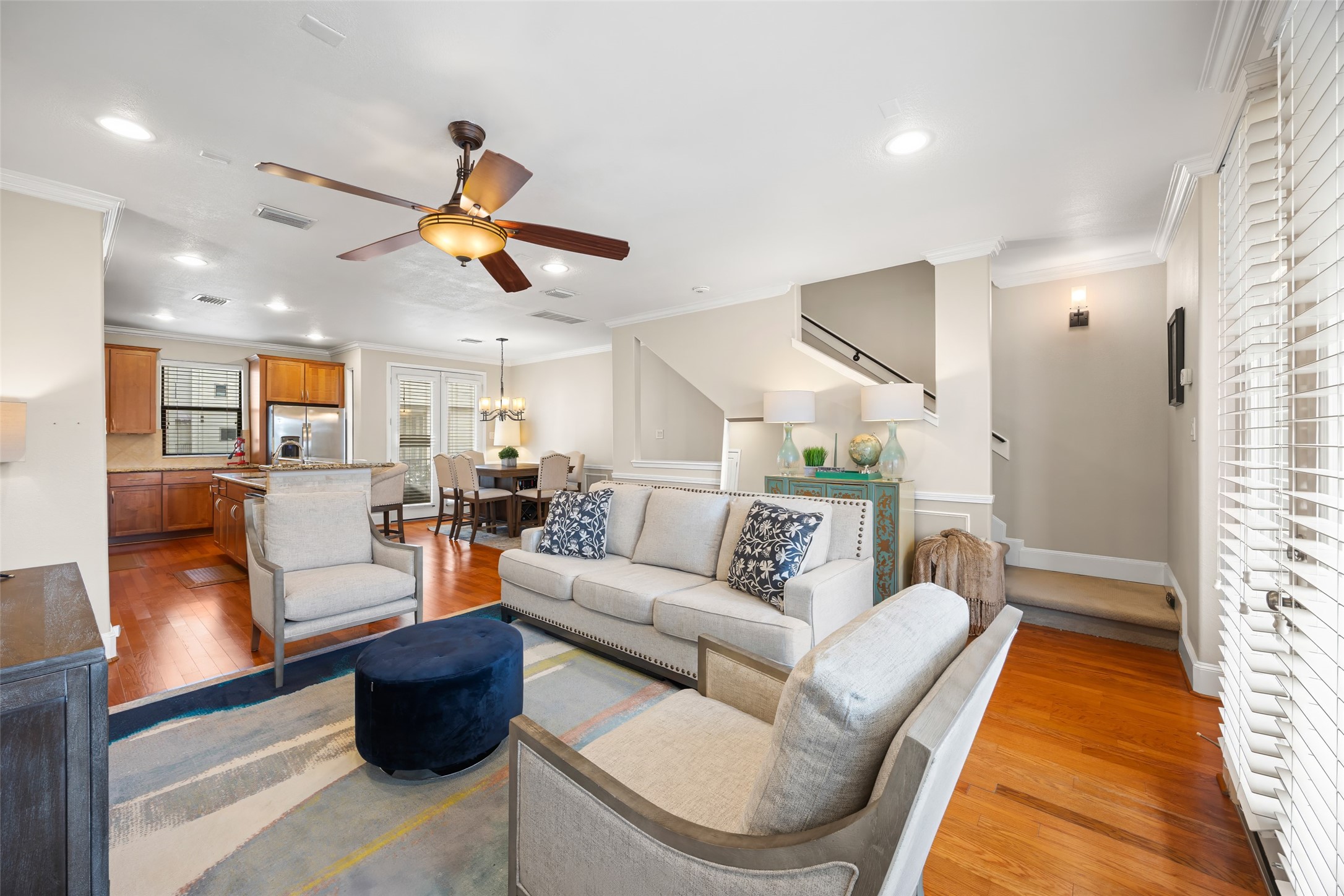a living room with furniture a rug and a chandelier
