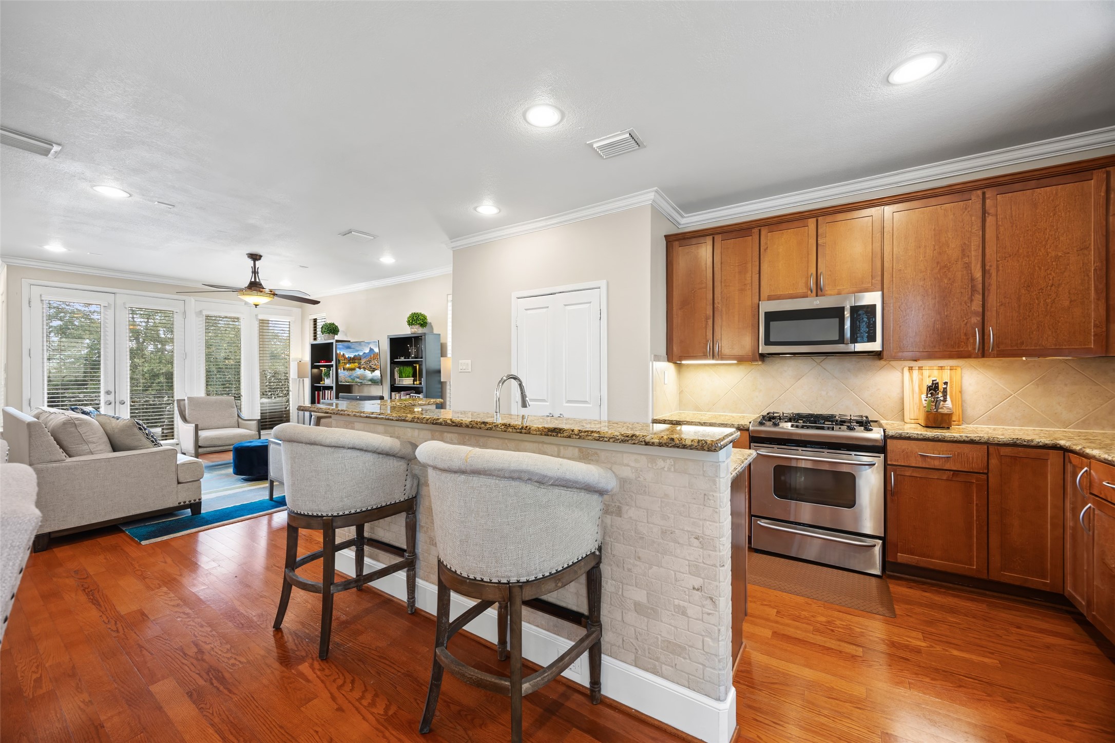2320 Emancipation Avenue Houston, TX 77004 - Photo 20 of 38 a kitchen with stainless steel appliances granite countertop counter space a sink and a refrigerator