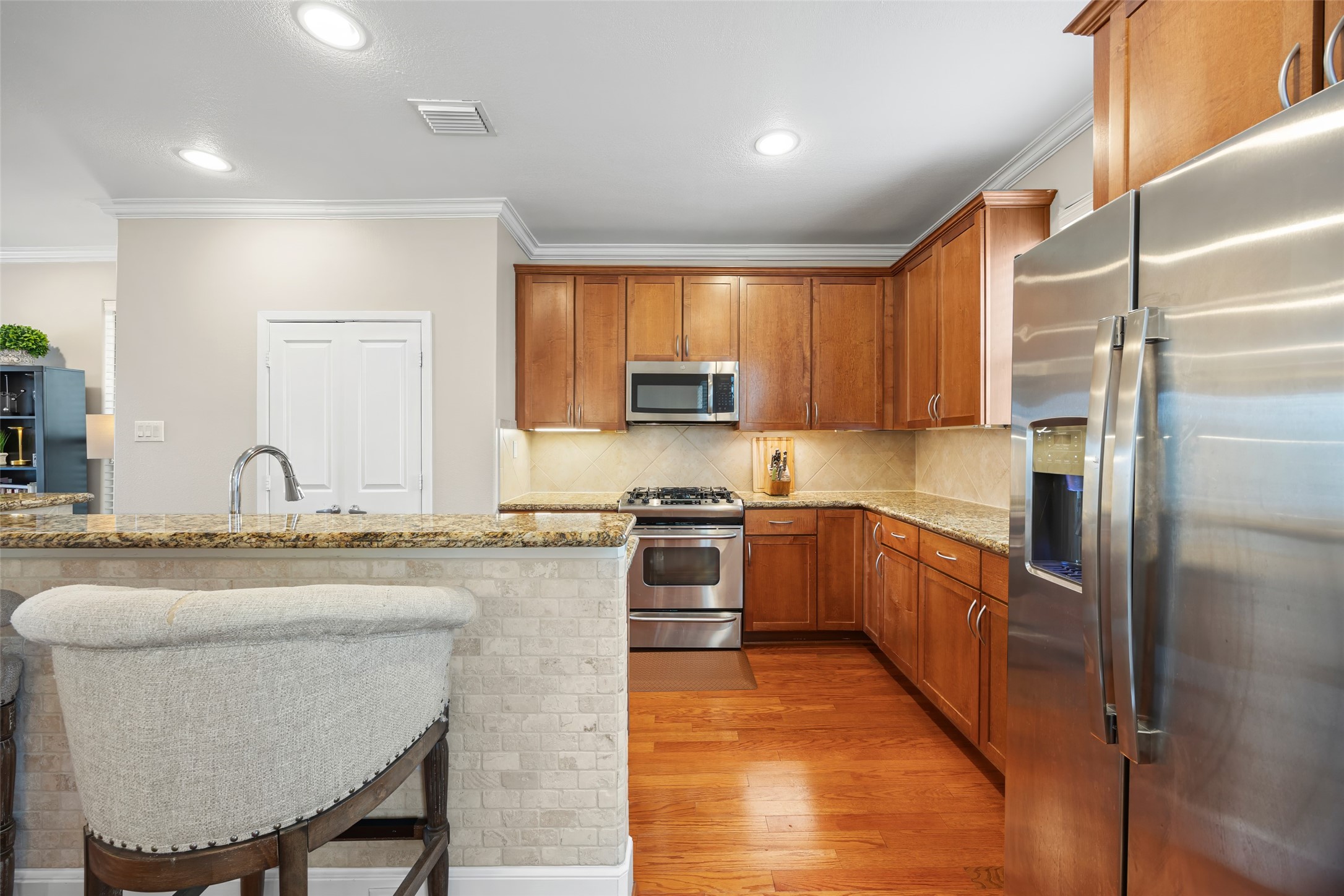 2320 Emancipation Avenue Houston, TX 77004 - Photo 21 of 38 a kitchen with granite countertop a stove top oven a sink dishwasher a refrigerator and cabinets with wooden floor