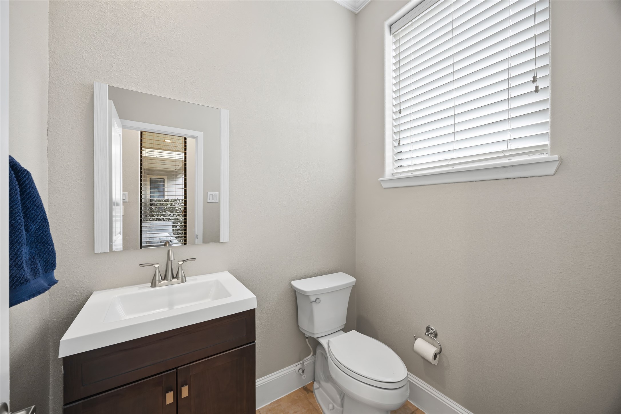 2320 Emancipation Avenue Houston, TX 77004 - Photo 23 of 38 a bathroom with a toilet a sink a mirror and a window