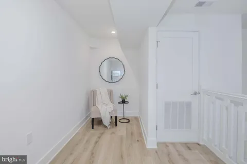 a view of a room with wooden floor table and chairs