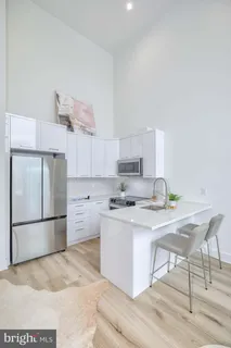 a kitchen with stainless steel appliances a stove a refrigerator and a refrigerator